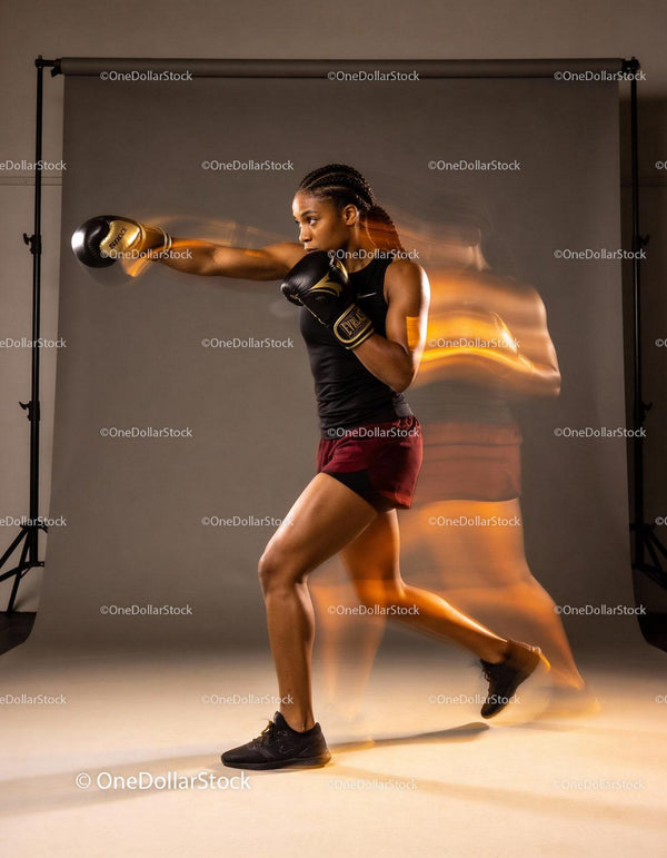 Focused female boxer delivering a powerful punch in motion