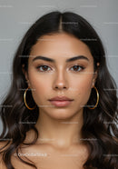 Elegant Woman with Wavy Hair and Brown Eyes in a Studio Portrait