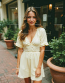 Woman in Light Yellow Dress Walking Outdoors in a City Setting