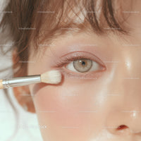 Close-up of Woman Applying Eye Makeup with Brush