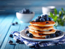 Blueberry Pancakes with Syrup on Rustic Blue Wooden Table