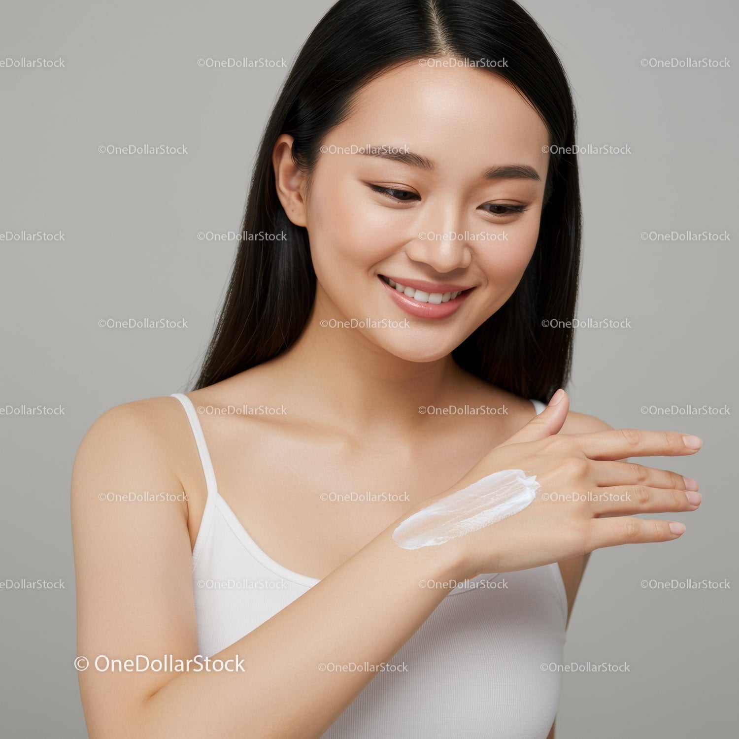 Young Woman Applying Facial Moisturizer with Cream on Hand