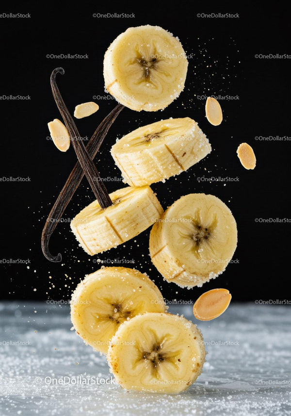 Banana slices with vanilla pods and peanut pieces in motion