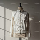 Minimalist white jacket on mannequin in soft sunlight