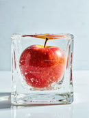 Red apple encapsulated in a clear ice cube