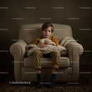 Boy Sitting Thoughtfully on Cozy Armchair