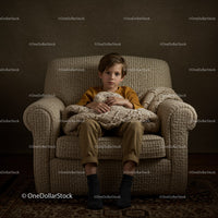 Boy Sitting Thoughtfully on Cozy Armchair