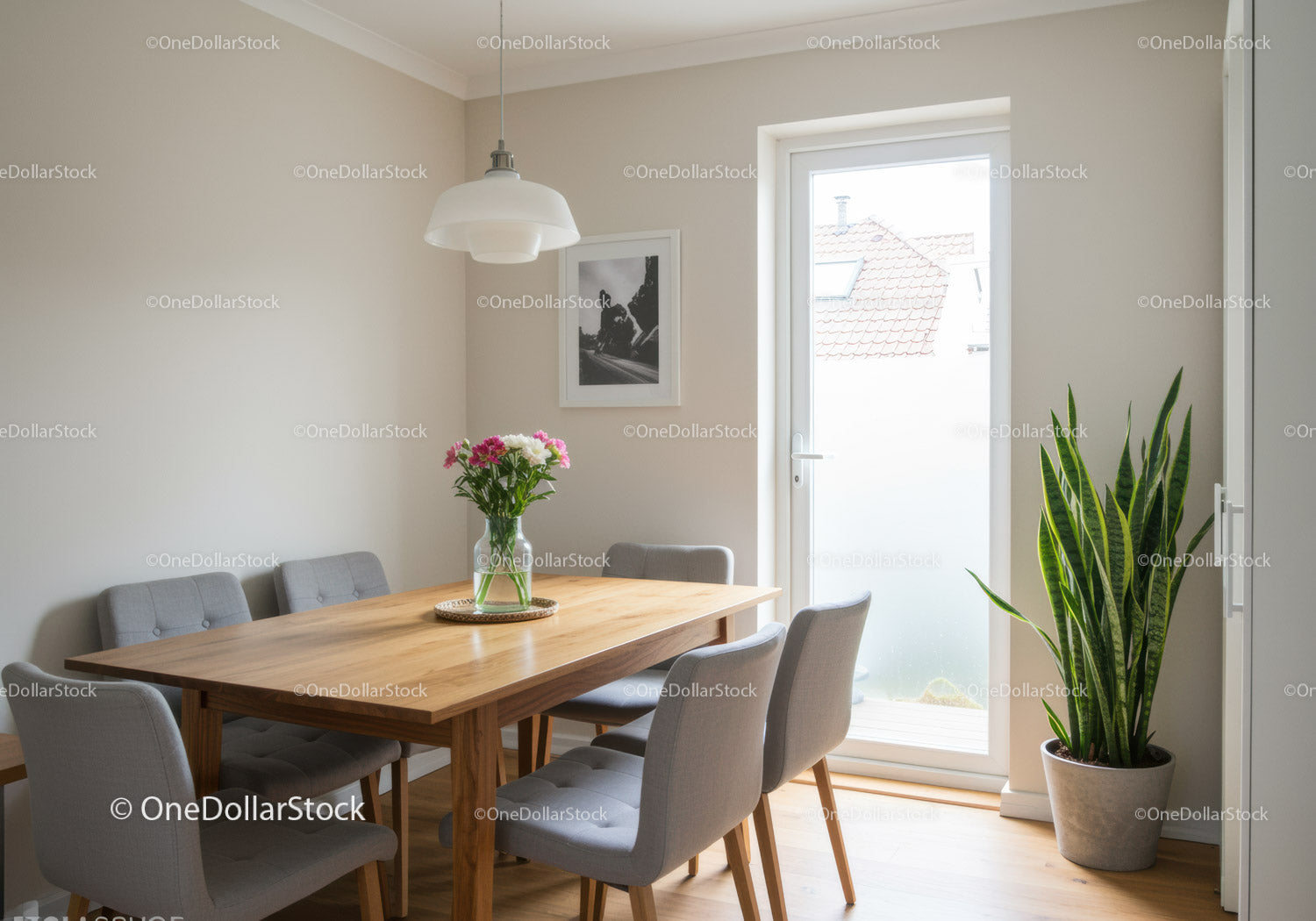 Modern Dining Room with Gray Upholstered Chairs and Green Plant
