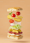 Fresh sandwich ingredients floating on beige background