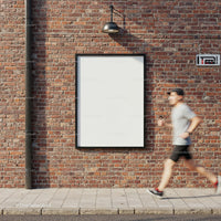 Runner passing empty urban billboard on brick wall