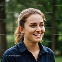 Smiling Young Woman in Nature with Green Foliage and Sunlight