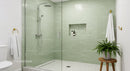 Modern minimalist bathroom with glass shower and greenery