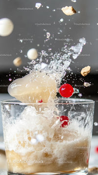 Ice Cubes and Red Cherries Splash in Refreshing Fizzy Drink