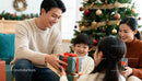 Family Sharing Holiday Joy and Gifts by Christmas Tree