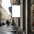 Empty outdoor cafe tables along quiet city street