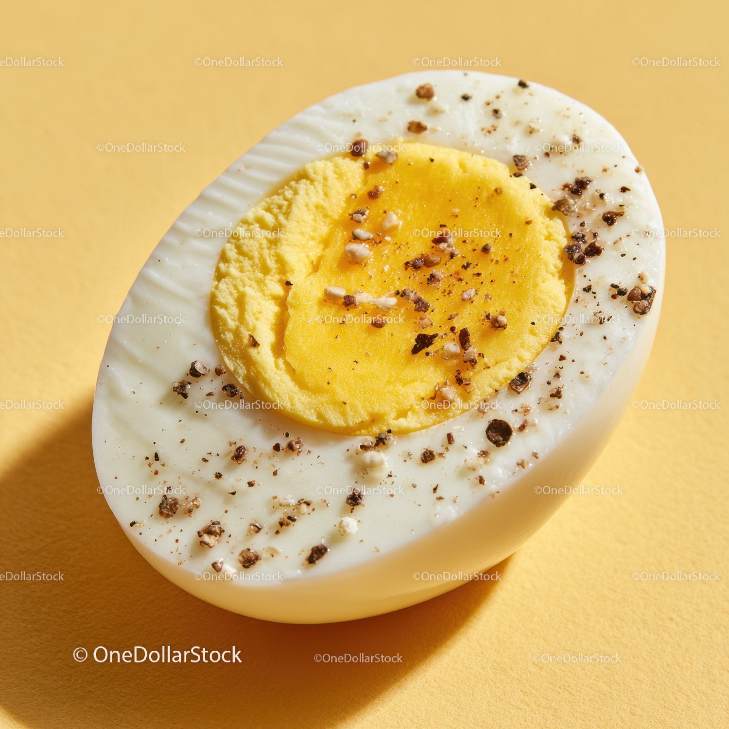 Close-up of a Hard Boiled Egg Cut in Half with Salt and Pepper