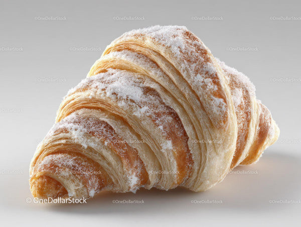 Golden Croissant Dusting of Powdered Sugar in Close-Up