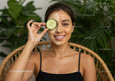 Relaxing Woman with Cucumber Face Mask and Greenery Background
