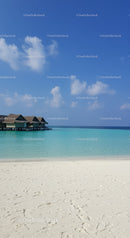 Tropical Beach with Overwater Bungalows and Calm Sea