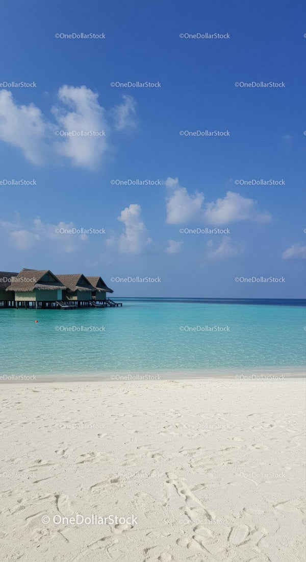 Tropical Beach with Overwater Bungalows and Calm Sea