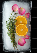 Fresh orange slices and herbs frozen in ice block