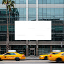 Yellow Taxis Passing a Modern Office Building Facade