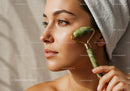 Woman Using Jade Roller for Facial Massage With Beautiful Skin and Towel