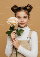 Young Girl Holding a Beautiful Cream Rose with Green Leaves