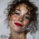 Young Woman with Curly Hair and Freckles Smiling Close-up Portrait