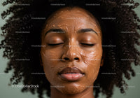 Close-up of Woman Applying Face Mask with Curly Hair and Relaxed Expression