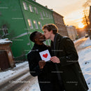 Couple sharing a tender kiss with heart card outdoors