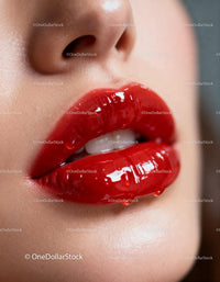 Glossy red lips close up with water droplets