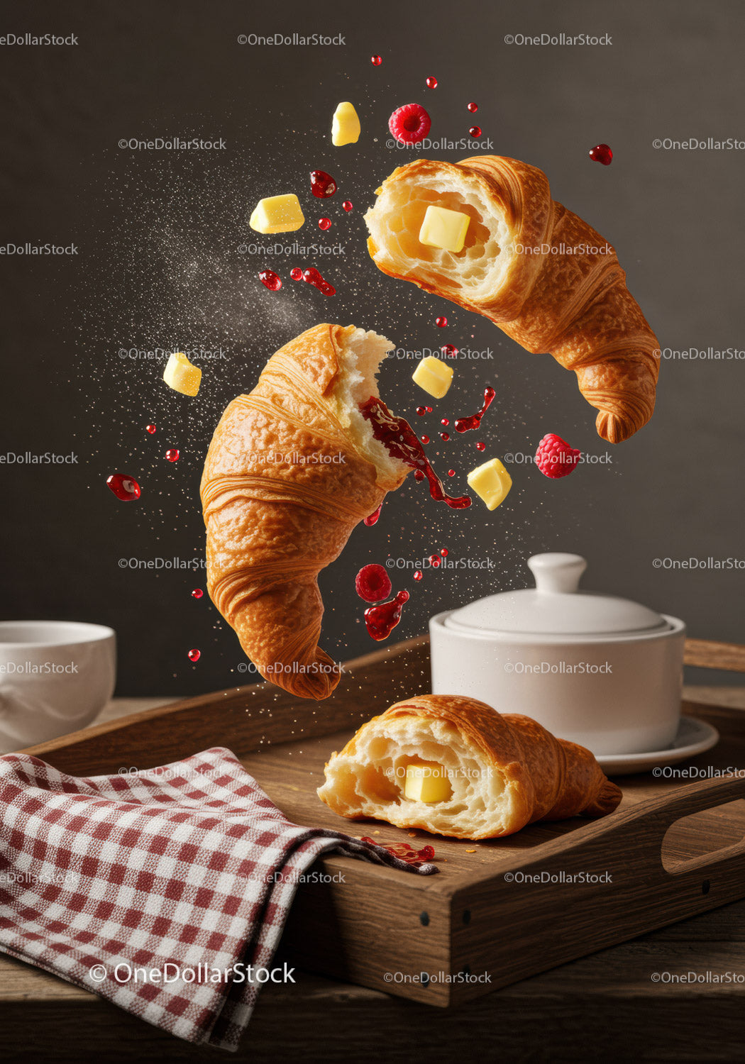 Fresh croissants with butter and raspberry jam splash