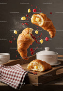 Fresh croissants with butter and raspberry jam splash