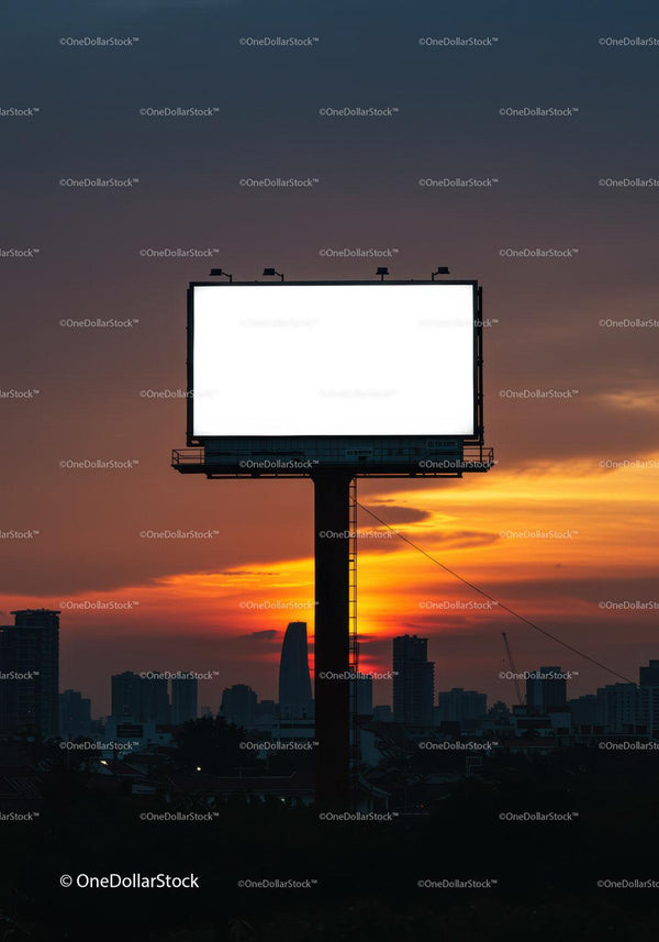 Empty illuminated billboard at sunset over cityscape skyline JPG Mockup Image