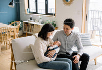 Young Couple Cherishing Their Newborn Baby at Home