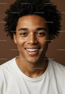 Young Man with Curly Hair and Freckles Smiling in Studio Portrait