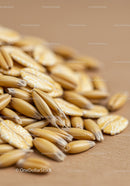 Close up of oat and oat flakes on brown surface
