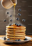 Stack of Pancakes with Blueberries and Honey Drizzle