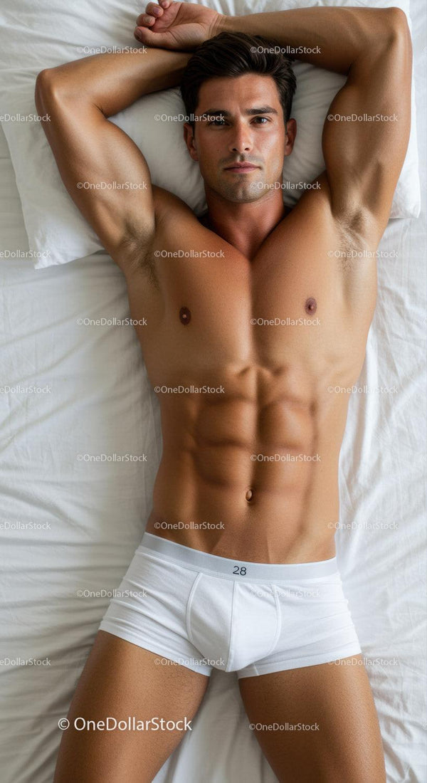 Fit young man relaxing on bed in white underwear