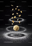 Almond coated ball with flying almond slices and powdered sugar