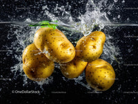 Fresh Yellow Potatoes Splashing into Water in Dynamic Food Scene