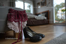 Chic Black Heels and a Red Lace Dress in a Cozy Bedroom Setting