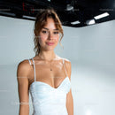 Young Woman in White Dress with Jewelry in Studio Setting