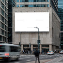Urban street scene with blank billboard on city building