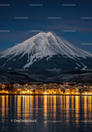 Snowy Mountain Overlooking Illuminated Waterfront Town