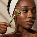African American Woman Using Jade Roller for Facial Skincare in Spa Setting
