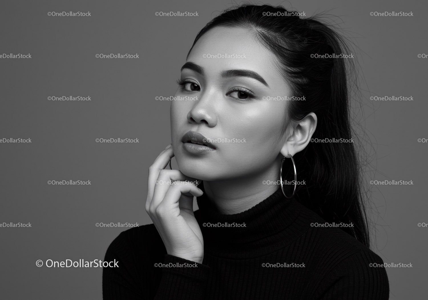 Elegant Black and White Portrait of a Woman with Hoop Earrings