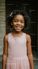 Smiling young girl in pink lace dress outdoors