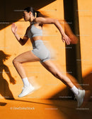 Athletic woman sprinting powerfully against wall